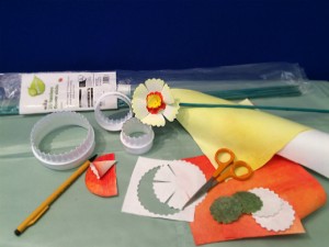 Items required to make the daffodils, including white fluted pastry cutters, scissors, transfer painted Evolon, a pack of green garden canes and a pencil.