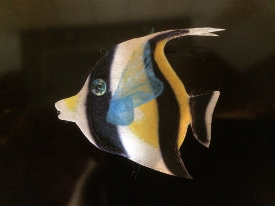 A black, yellow and white striped Moorfish made out of Zeelon Heavy, with transparent blue fins and a bright sequin eyes.