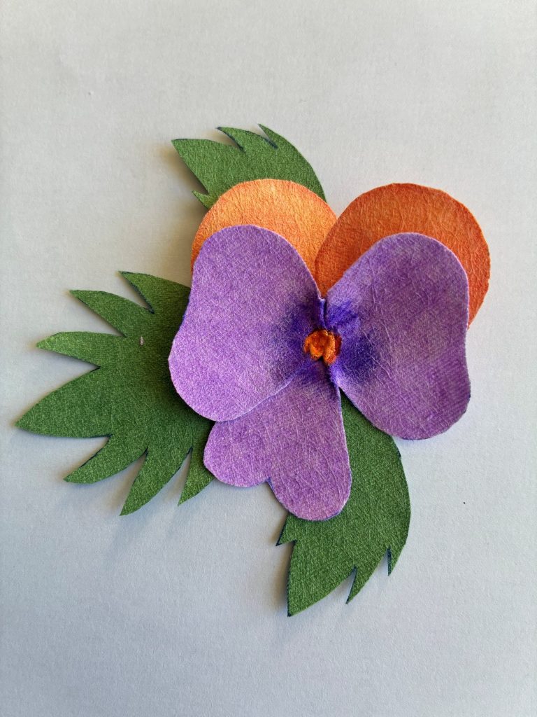 Finally, the two sets of petals and the leaves are combined to form one complete flower.