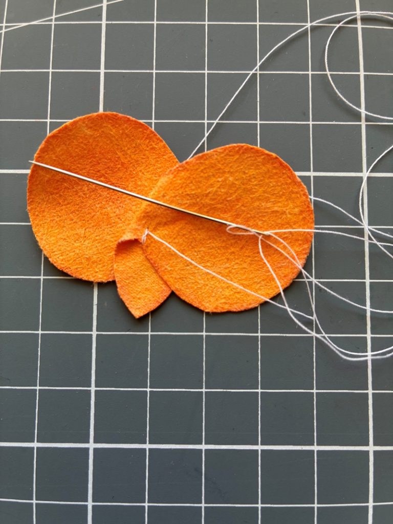 The back orange petals being overlapped and sewn in position for added realism.